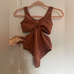 NWOT Sugar Rain one piece body suit. size S/M. never Worn before